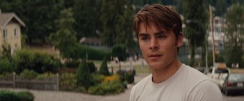 Movie still from “Charlie St. Cloud” (2010), directed by Burr Steers – A person wearing a white t - shirt; Close Up shot, Over the shoulder angle