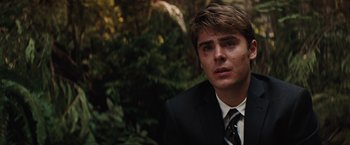 Movie still from “Charlie St. Cloud” (2010), directed by Burr Steers – A man in a suit and tie looking at the camera; Close Up shot, Over the shoulder angle