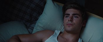 Movie still from “Charlie St. Cloud” (2010), directed by Burr Steers – A man laying in a bed with a pillow; Close Up shot, High angle