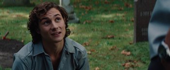 Movie still from “Charlie St. Cloud” (2010), directed by Burr Steers – A man sitting on the grass looking up at the sky; Close Up shot, Over the shoulder angle