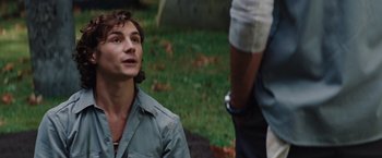 Movie still from “Charlie St. Cloud” (2010), directed by Burr Steers – A man in a green shirt is talking to another man in a white shirt; Close Up shot, Over the shoulder angle