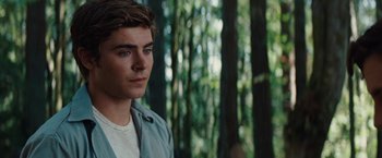 Movie still from “Charlie St. Cloud” (2010), directed by Burr Steers – A man standing in the middle of a forest looking to his left; Close Up shot, Over the shoulder angle