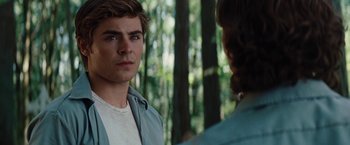 Movie still from “Charlie St. Cloud” (2010), directed by Burr Steers – A man standing next to another man in the woods; Close Up shot, Over the shoulder angle