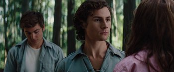 Movie still from “Charlie St. Cloud” (2010), directed by Burr Steers – A young man in a blue shirt is in the woods; Close Up shot, Over the shoulder angle