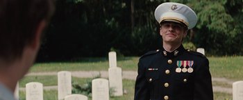 Movie still from “Charlie St. Cloud” (2010), directed by Burr Steers – A man in a military uniform standing in front of some grave markers; Medium shot, Over the shoulder angle