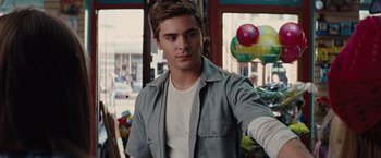 Movie still from “Charlie St. Cloud” (2010), directed by Burr Steers – A man standing in front of a building with balloons; Medium shot, Over the shoulder angle