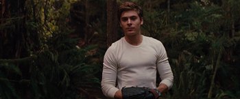 Movie still from “Charlie St. Cloud” (2010), directed by Burr Steers – A man in a white shirt is standing in the woods; Medium shot, Over the shoulder angle