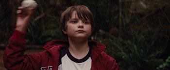 Movie still from “Charlie St. Cloud” (2010), directed by Burr Steers – A young boy in a red jacket looking at the camera; Close Up shot, Low angle