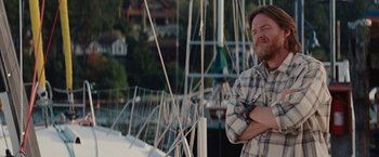 Movie still from “Charlie St. Cloud” (2010), directed by Burr Steers – A man standing next to a boat on the water; Medium shot, Low angle