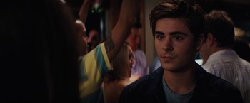 Movie still from “Charlie St. Cloud” (2010), directed by Burr Steers – A man with a tattoo is looking at the camera; Close Up shot, Over the shoulder angle