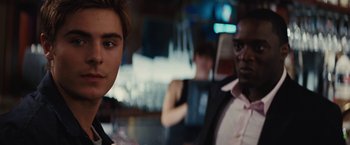 Movie still from “Charlie St. Cloud” (2010), directed by Burr Steers – A man in a suit and tie next to another man in a suit and tie; Close Up shot, Over the shoulder angle