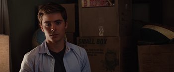 Movie still from “Charlie St. Cloud” (2010), directed by Burr Steers – A young man standing in front of boxes in a room; Close Up shot, Over the shoulder angle