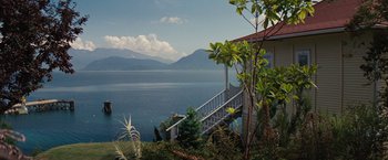 Movie still from “Charlie St. Cloud” (2010), directed by Burr Steers – A view of a lake from a house with a deck; Extreme Wide shot, High angle