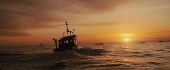 Movie still from “Charlie St. Cloud” (2010), directed by Burr Steers – A small boat in the middle of the ocean at sunset; Extreme Wide shot, Low angle