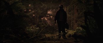 Movie still from “Charlie St. Cloud” (2010), directed by Burr Steers – A man in a helmet is standing in the woods at night; Wide shot, Low angle