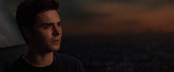 Movie still from “Charlie St. Cloud” (2010), directed by Burr Steers – A young man is standing in front of a city skyline; Close Up shot, Over the shoulder angle
