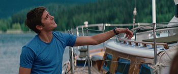 Movie still from “Charlie St. Cloud” (2010), directed by Burr Steers – A man standing on a boat with his arms outstretched; Medium shot, Over the shoulder angle