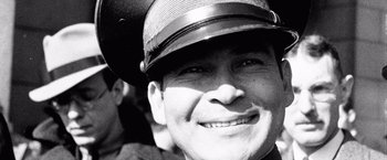 Movie still from “Che: Part One” (2008), directed by Steven Soderbergh – Black and white photograph of a man wearing a hat; Extreme Close Up shot, Over the shoulder angle