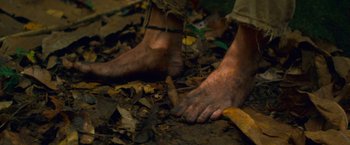 Movie still from “Che: Part One” (2008), directed by Steven Soderbergh – A man's bare feet are shown on the ground; Extreme Close Up shot, High angle