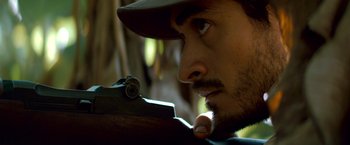 Movie still from “Che: Part One” (2008), directed by Steven Soderbergh – A person with a rifle; Extreme Close Up shot, Low angle