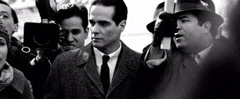 Movie still from “Che: Part One” (2008), directed by Steven Soderbergh – A black and white photo of a man in a suit and tie; Close Up shot, Over the shoulder angle