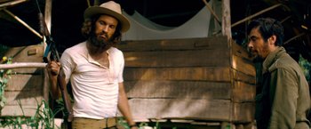 Movie still from “Che: Part One” (2008), directed by Steven Soderbergh – A man with a long beard wearing a hat; Medium shot, Low angle