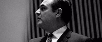 Movie still from “Che: Part One” (2008), directed by Steven Soderbergh – Black and white photograph of a man wearing a suit and tie; Close Up shot, Low angle