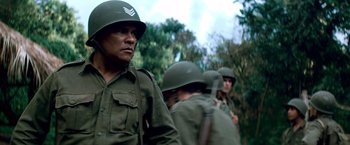 Movie still from “Che: Part One” (2008), directed by Steven Soderbergh – A group of men in military fatigues and helmets; Medium shot, Low angle