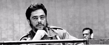 Movie still from “Che: Part One” (2008), directed by Steven Soderbergh – A black - and - white photo of a man with a beard; Close Up shot, Over the shoulder angle