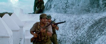 Movie still from “Che: Part One” (2008), directed by Steven Soderbergh – A group of men with guns in the snow; Medium shot, Low angle