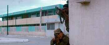 Movie still from “Che: Part One” (2008), directed by Steven Soderbergh – Two men are standing next to each other; Medium shot, Low angle