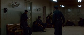 Movie still from “Che: Part One” (2008), directed by Steven Soderbergh – A group of people sitting in a room next to each other; Wide shot, High angle