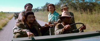 Movie still from “Che: Part One” (2008), directed by Steven Soderbergh – A group of people riding in the back of a truck; Medium shot, Low angle