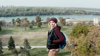 Movie still from “Chernobyl Diaries” (2012), directed by Bradley Parker – A woman standing on top of a grass covered hill; Wide shot, High angle