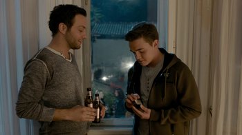 Movie still from “Chernobyl Diaries” (2012), directed by Bradley Parker – Two young men standing next to each other; Medium shot, High angle
