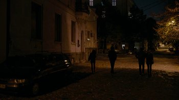 Movie still from “Chernobyl Diaries” (2012), directed by Bradley Parker – Two people walking down a street at night; Wide shot, High angle