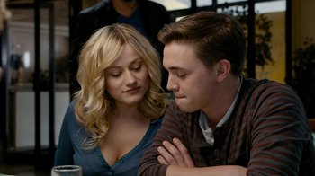 Movie still from “Chernobyl Diaries” (2012), directed by Bradley Parker – A man and a woman sitting next to each other at a table; Close Up shot, Over the shoulder angle