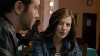 Movie still from “Chernobyl Diaries” (2012), directed by Bradley Parker – A man and a woman sitting in front of each other in a room; Close Up shot, Over the shoulder angle
