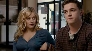 Movie still from “Chernobyl Diaries” (2012), directed by Bradley Parker – A man and a woman sitting next to each other in a room; Close Up shot, Over the shoulder angle