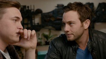 Movie still from “Chernobyl Diaries” (2012), directed by Bradley Parker – A person wearing a leather jacket; Close Up shot, Over the shoulder angle