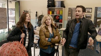 Movie still from “Chernobyl Diaries” (2012), directed by Bradley Parker – A group of people standing around in a room together; Medium shot, Over the shoulder angle