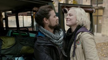 Movie still from “Chernobyl Diaries” (2012), directed by Bradley Parker – A man and a woman are standing next to each other; Close Up shot, Over the shoulder angle