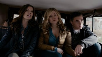 Movie still from “Chernobyl Diaries” (2012), directed by Bradley Parker – A group of people sitting in the back of a car; Medium shot, High angle