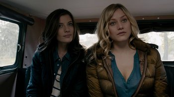 Movie still from “Chernobyl Diaries” (2012), directed by Bradley Parker – Two women standing next to each other in a car; Close Up shot, Low angle