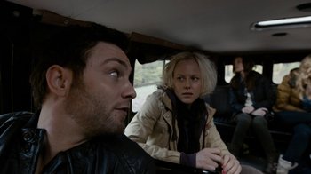 Movie still from “Chernobyl Diaries” (2012), directed by Bradley Parker – A man and a woman sitting in the back of a car; Close Up shot, Over the shoulder angle