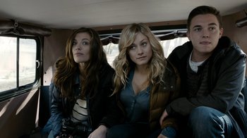 Movie still from “Chernobyl Diaries” (2012), directed by Bradley Parker – A group of people sitting in the back of a vehicle; Medium shot, High angle