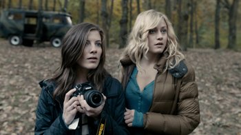 Movie still from “Chernobyl Diaries” (2012), directed by Bradley Parker – Two young women are standing in the woods; Medium shot, Over the shoulder angle