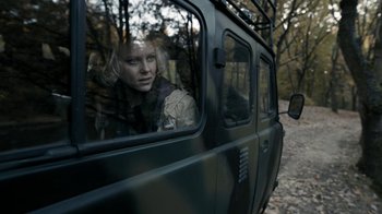 Movie still from “Chernobyl Diaries” (2012), directed by Bradley Parker – A woman looking out of the window of a vehicle; Medium shot, Over the shoulder angle