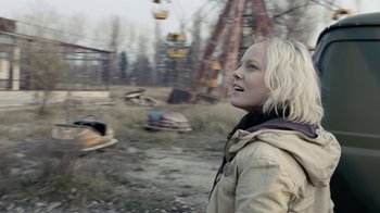 Movie still from “Chernobyl Diaries” (2012), directed by Bradley Parker – A woman standing in the middle of an abandoned amusement park; Close Up shot, Low angle