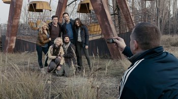 Movie still from “Chernobyl Diaries” (2012), directed by Bradley Parker – A man taking a picture of a group of people; Wide shot, High angle